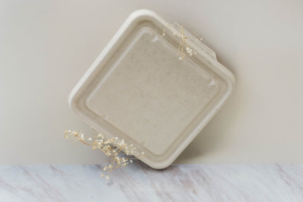 Beige biodegradable placenta container with dried flowers for decoration around it
