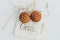 Cosy Mama Birth Orbs on a white labelled pouch with dried flowers around