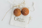 Cosy Mama Birth Orbs on a white labelled pouch with dried flowers around
