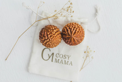 Cosy Mama Birth Orbs on a white labelled pouch with dried flowers around