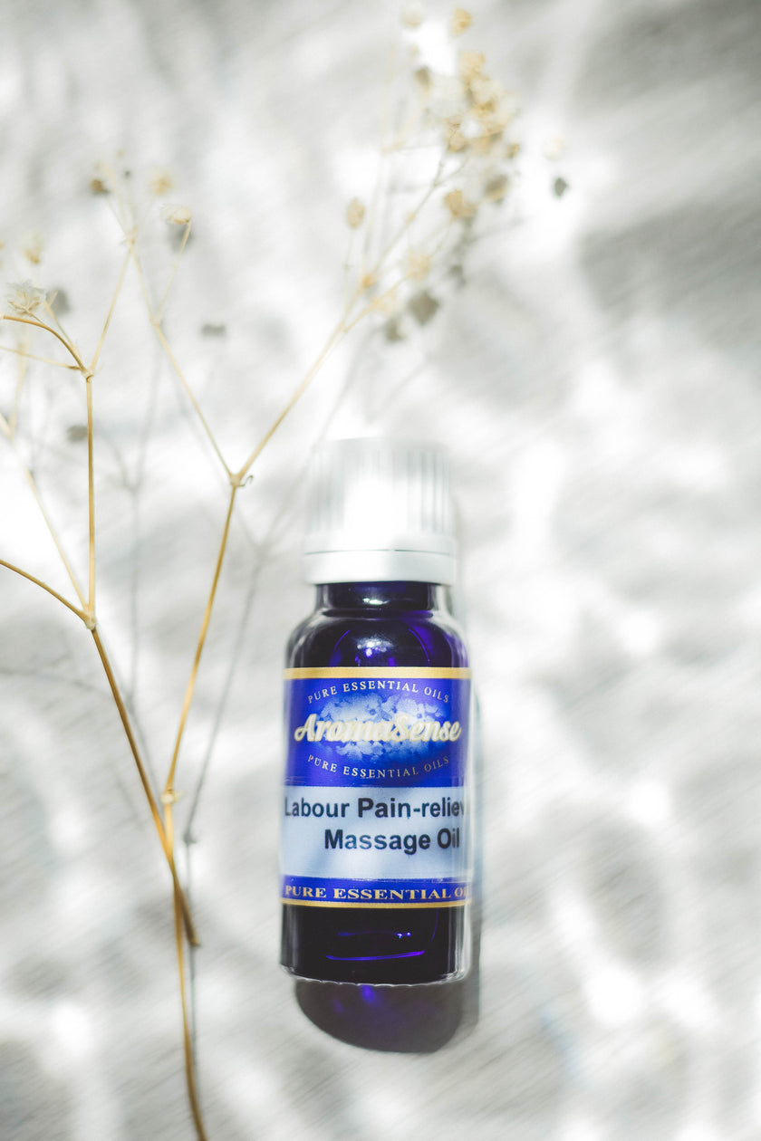 Bottle of Labour Pain-relief Massage Oil with a blue label on a white background