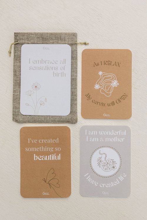 Set of four birth affirmation cards with text and illustrations on a beige background