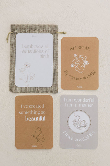 Set of four birth affirmation cards with text and illustrations on a beige background