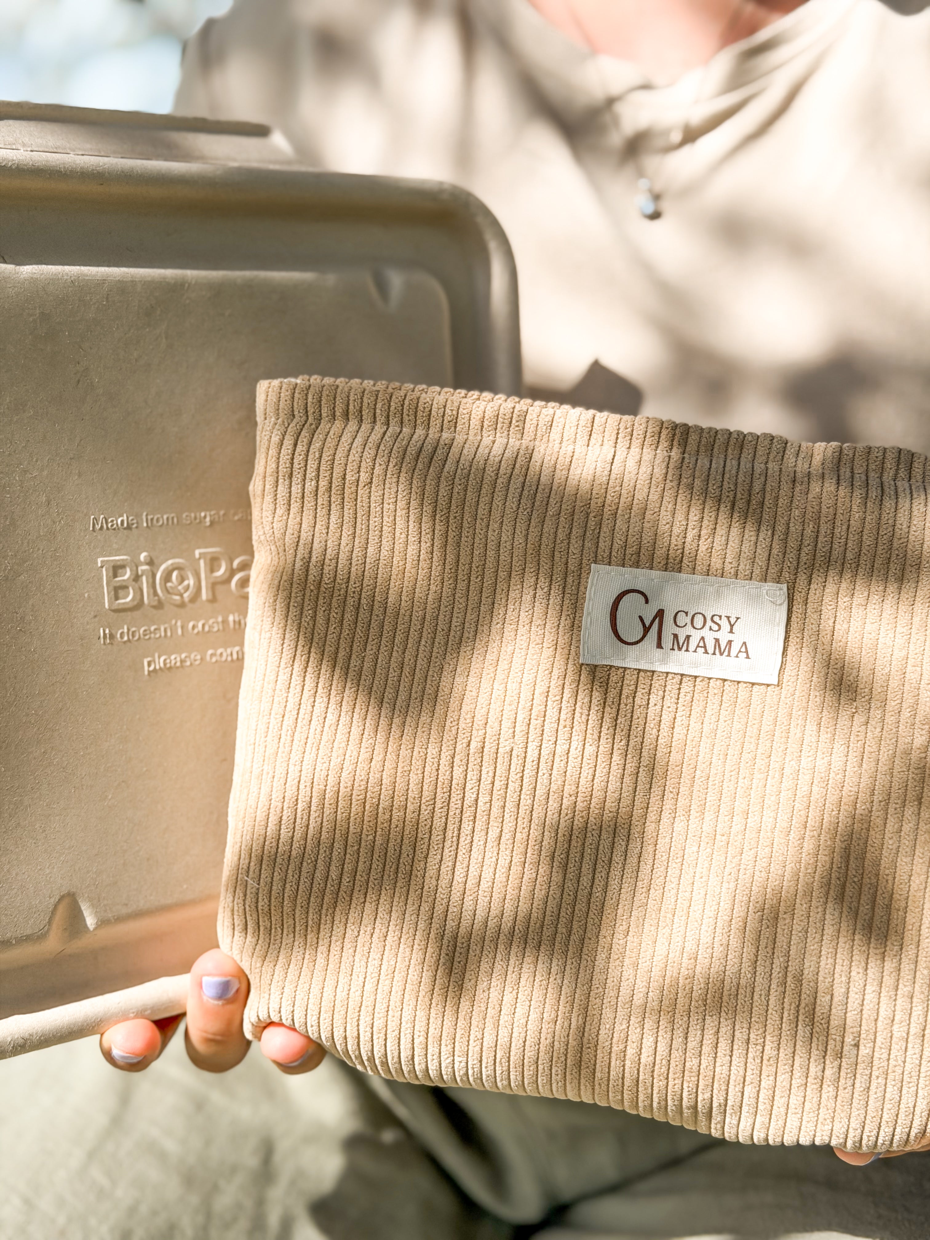 A person holding a beige ribbed birth bag and beige placenta container - Cosy Mama