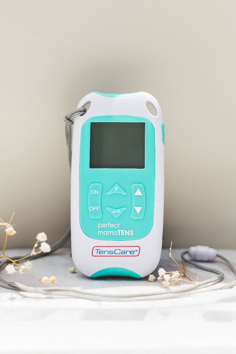 TENS Machine with dried flowers around for decoration
